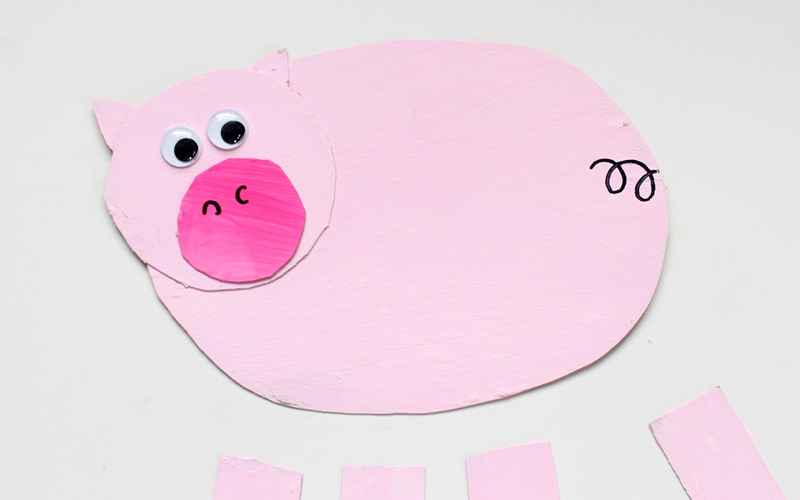 Attach googly eyes and draw curly tail for pig puppet