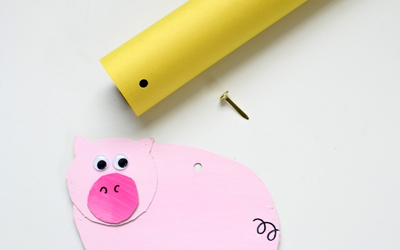 Attach pig puppet to a cardboard tube using a bracket