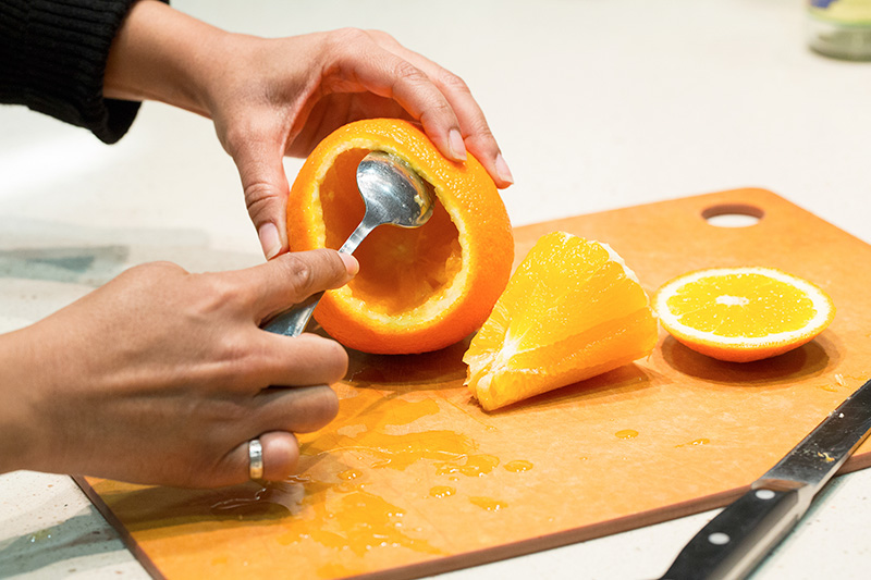 Scoop out the orange pulp using a spoon