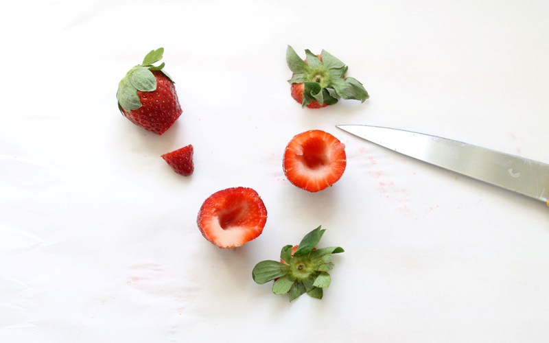 Cut the tops and bottoms of the strawberry