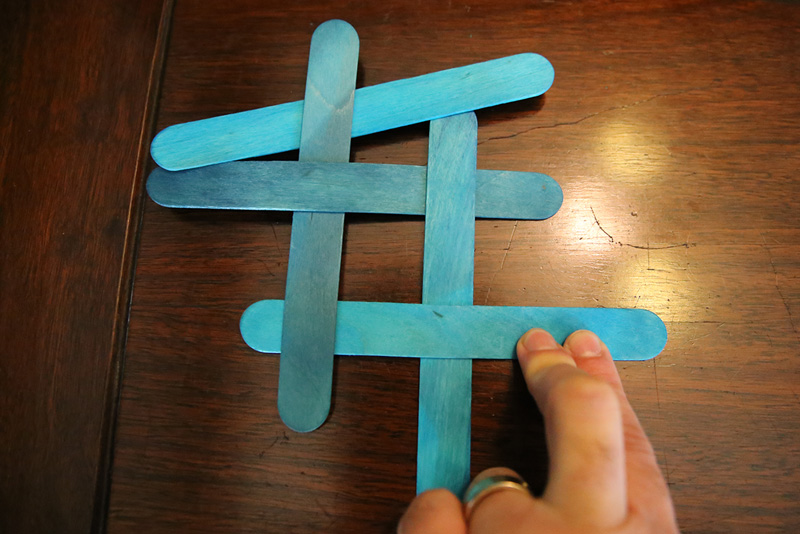 Interweave craft sticks to create friction.