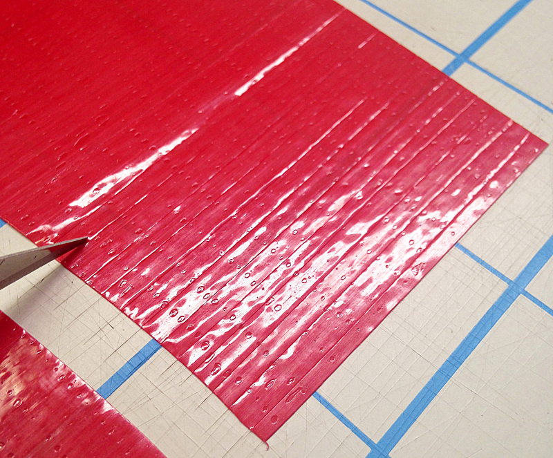 cut small strips from red tape