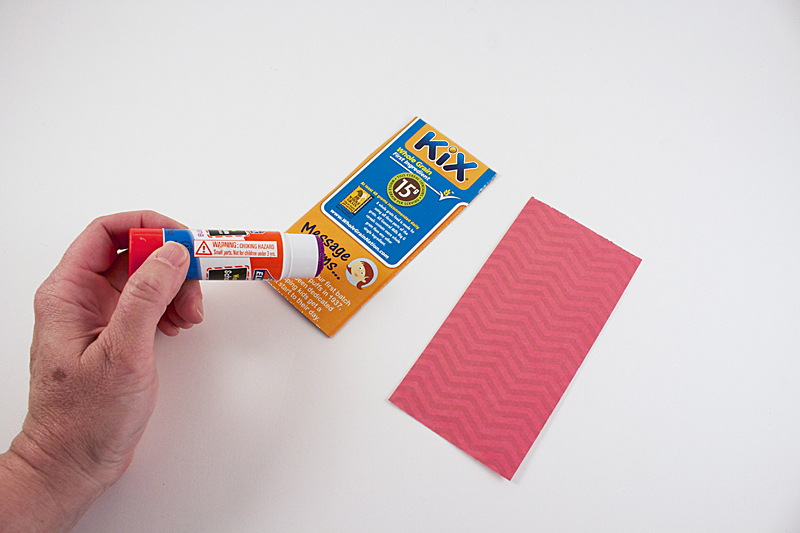 Attach scrapbook paper to the cereal box