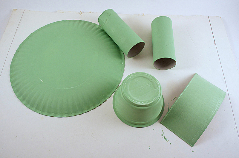 Paint the paper plate, cardboard tubes and other items light green